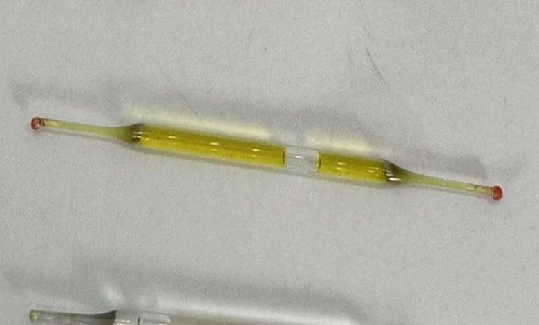 What could this be? Found beneath a bathroom vanity during renovations—tiny glass tubes, roughly 2 inches long, containing liquid. Any thoughts?